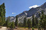 Granite peaks above the flat sandy trail near the Road's End trailhead.