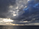 Trade winds and April showers create dramatic shafts of light as we leave sight of land