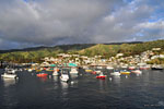 Sun breaks through a misty rain as the ferry arrives in cozy Avalon harbor.